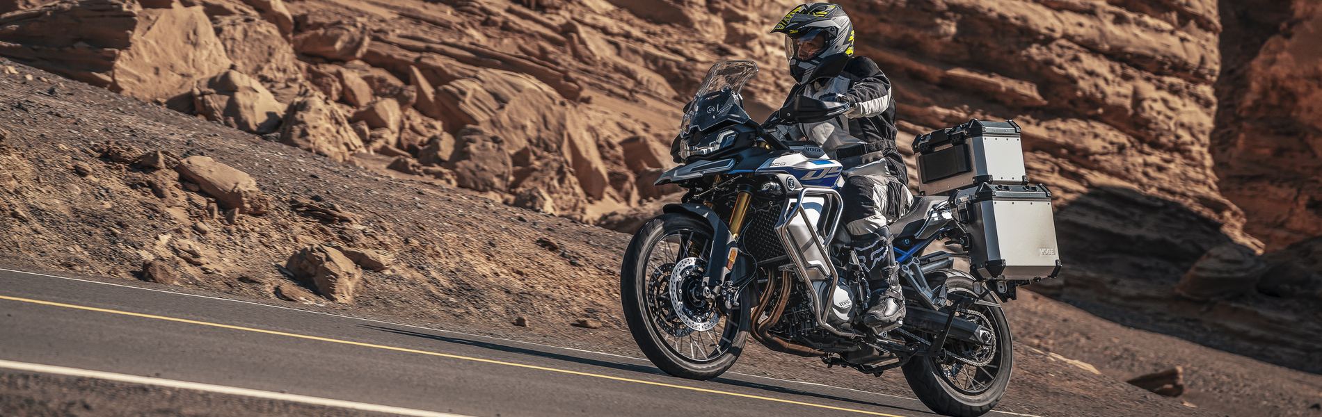 An adventure motorcycle with panniers on a mountain road